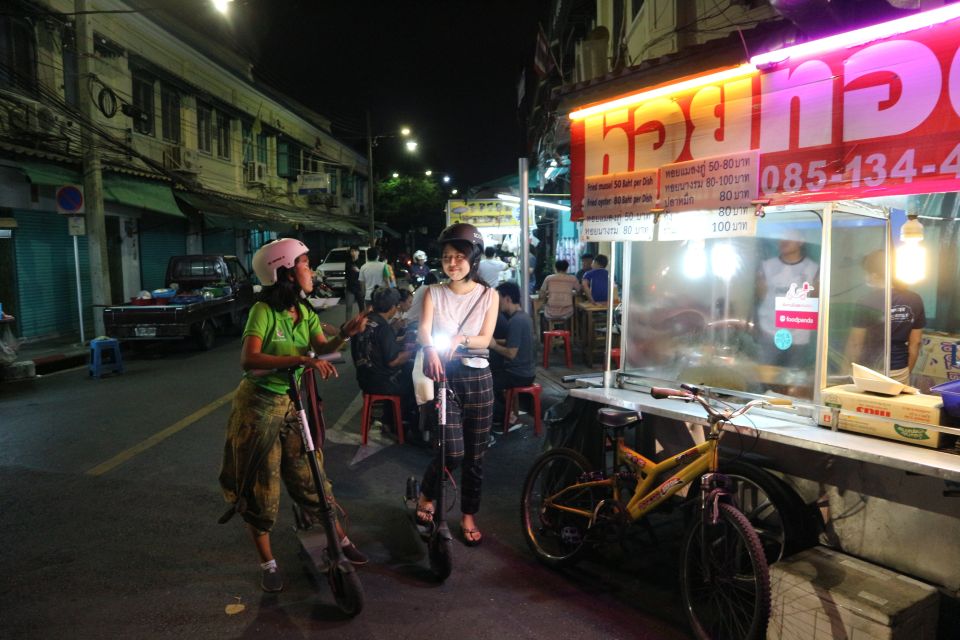 Bangkok: E-Scooter Night Tour with Local Street Food - Temple lighting without the heavy crowds stress