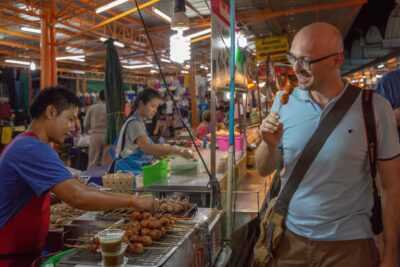 Bangkok: Markets, Temples and Food Night Tour by Tuk Tuk - Wat Prayoon and temple grounds after dark: what to expect when interiors close