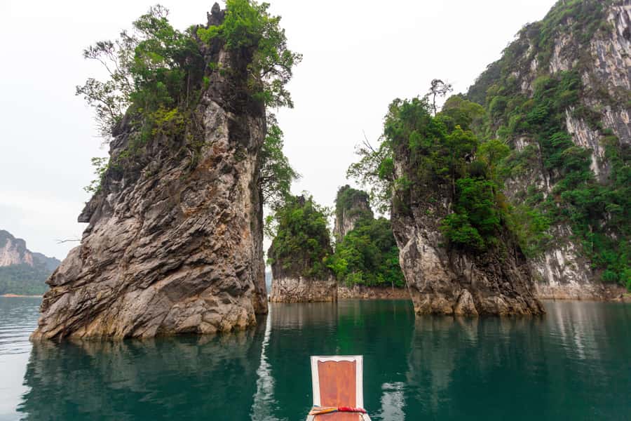 From Khao Lak/Khao Sok: Cheow Lan Lake and Emerald Pool Tour - Cheow Lan Lake by boat: Three-brother Pillar and that sudden sense of scale