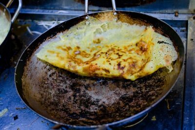 Private Street Food Evening Walking Tour in Ho Chi Minh City - Stop 1 at Street Food Man: Rice Pancakes and Leaving Tourist Streets Behind