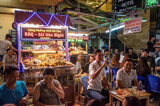 Saigon Night Bites on Foot: Local Vendors, Stories & Sweet Finish - Market and everyday Saigon: Ong Lanh Bridge Market views from street level